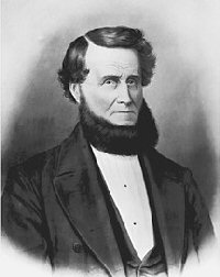 black and white historic photo of man in suit with large beard